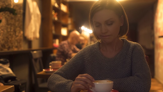 Sad woman sitting in cafe, painfully experiencing break-up, loneliness, crisis