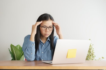 Asian women stressful working with a computer for a long time, Office syndrome concept