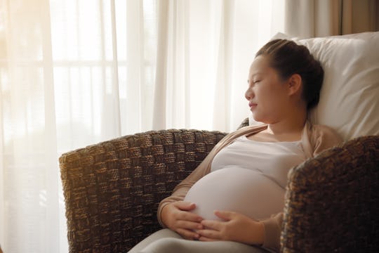 Asian pregnant woman sleeping
on the sofa