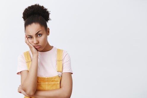 Woman hates when friend complaining on her life, staring with indifferent and bored expression, lean...