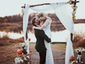  bride and groom on wedding ceremony on rustic autumn wedding