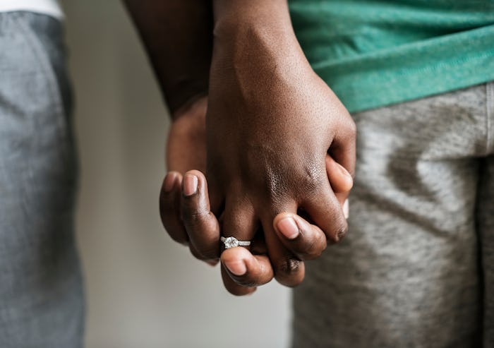 Couple holding hands closeup