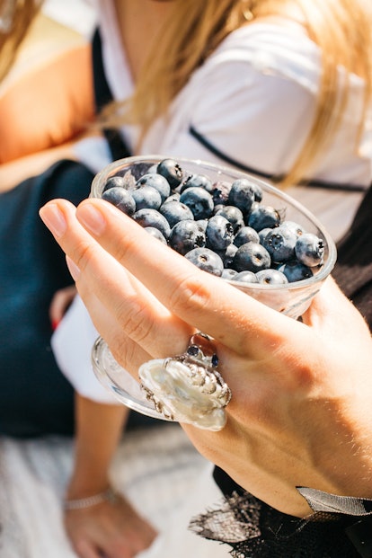 Woman offers freshly picked blueberries