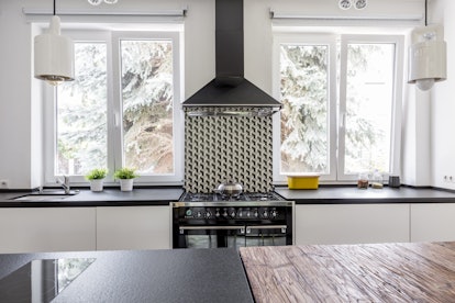 Black gas cooker and eave in a black and white modern kitchen