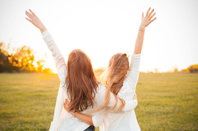 Young women are having fun on the green field in the evening.