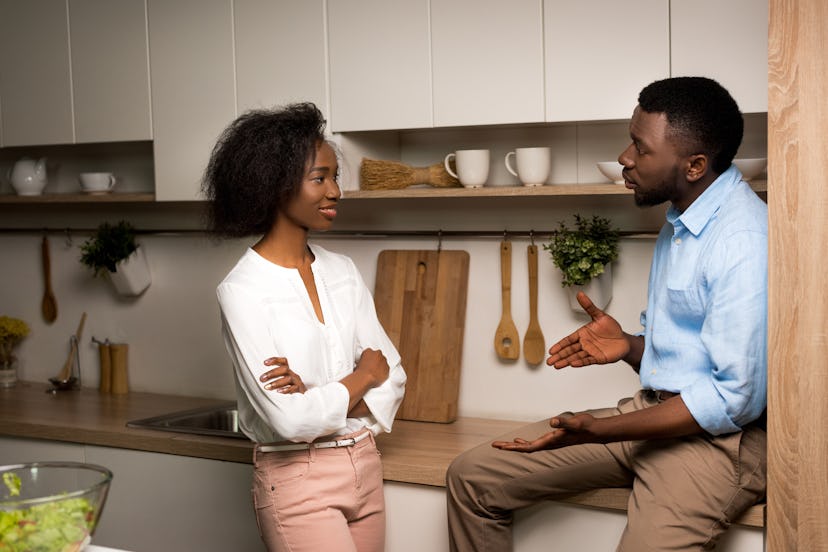 African american couple talking in kitchen