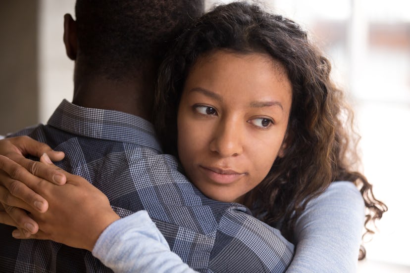 Pensive young mixed race girlfriend think of something hugging boyfriend making peace after fight, w...