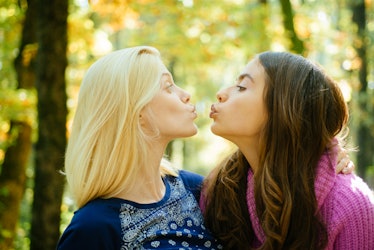 Friendly kiss. Glad to see you. Girls friends kissing. Girlish friendship concept. Blonde and brunet...