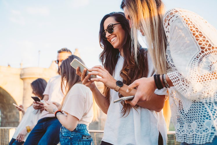 Group of friends watching media on a smartphone