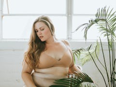 Beautiful and confident plus size woman in nude underwear
