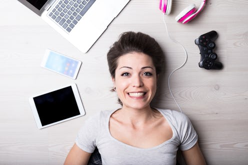 woman with creative entertainment tools for her time off, to write read surf play or listen some mus...