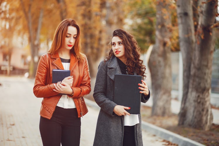 Girls are walking. Girls on the street. Beautiful girlі with computer