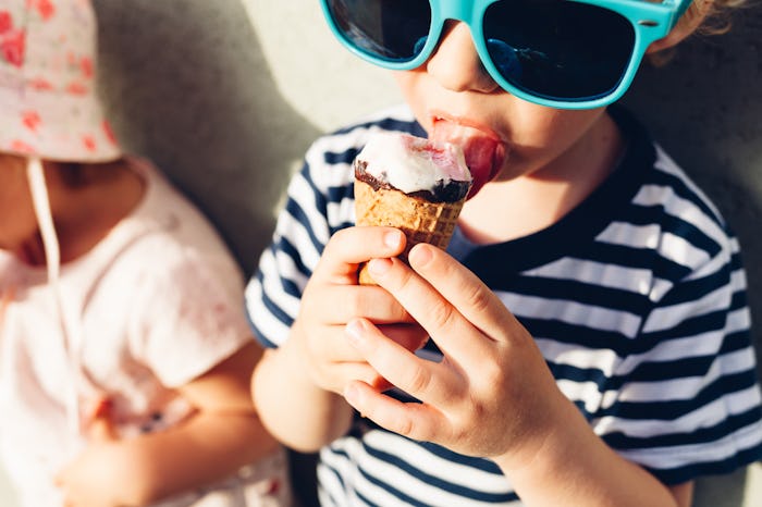 Cute little boy eating ice cream in closeup