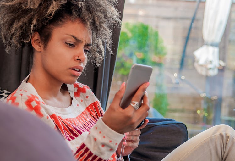 woman with worried expression on the phone. stressed shocked young  woman, talking on cellular, havi...