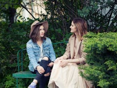 Pretty girls young friends chatting outdoors, lifestyle portrait