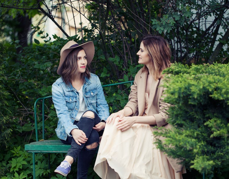 Pretty girls young friends chatting outdoors, lifestyle portrait