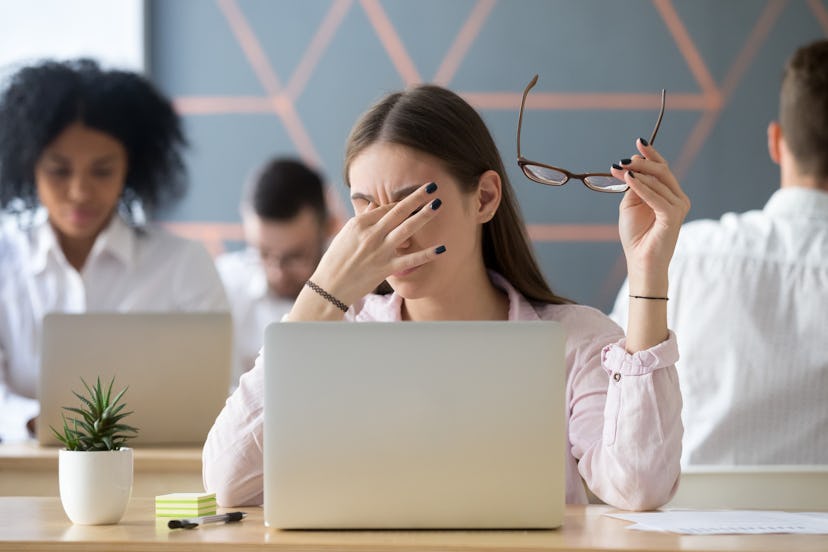Young woman taking off glasses tired of computer work, exhausted student or employee suffering from ...