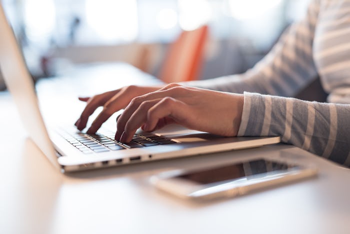 Young female Entrepreneur Freelancer Working Using A Laptop In Coworking space