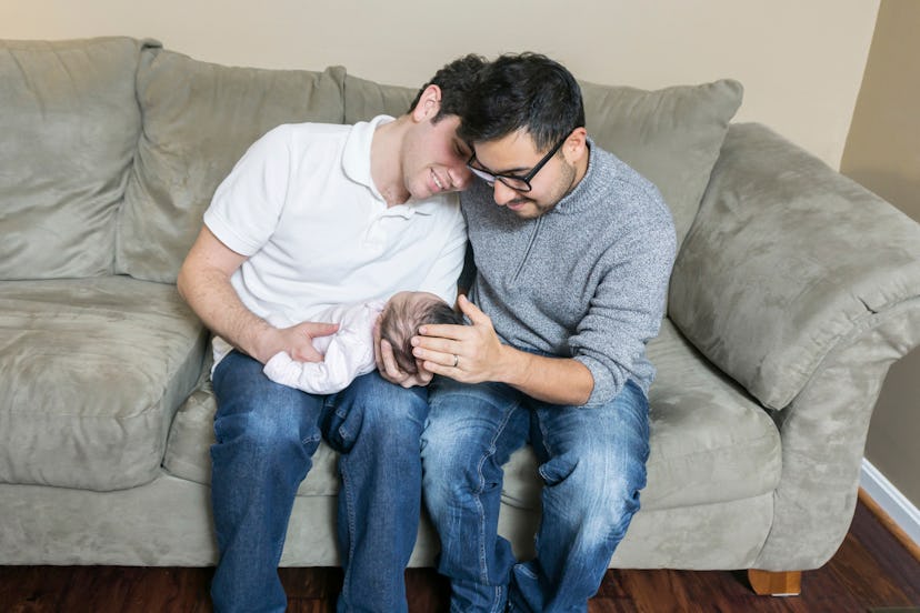 Young gay couple with adopted baby