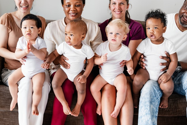 Diverse babies with their parents.
