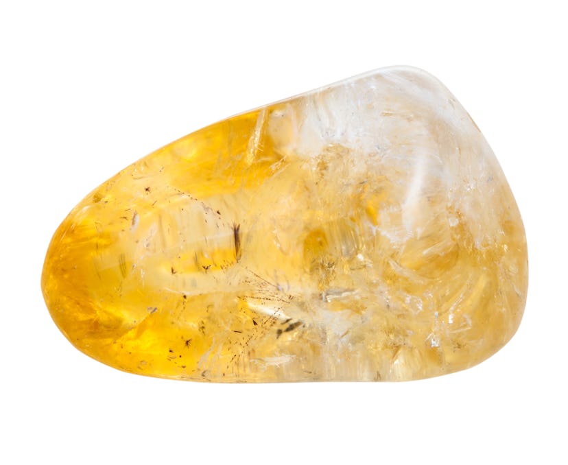 macro shooting of natural gemstone - pebble of citrine mineral gem stone isolated on white backgroun...