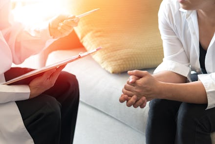 Doctor and patient healthcare concept. Gynecologist physician consulting and examining woman patient...