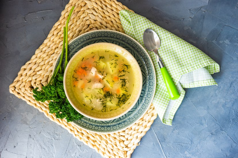 Healthy food concept with chicken soup on rustic background with copy space