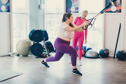 Fat woman works out in gym to lose weight