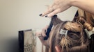 Hairdresser cutting bangs for woman with fine hair
