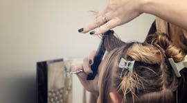 Hairdresser cutting bangs for woman with fine hair