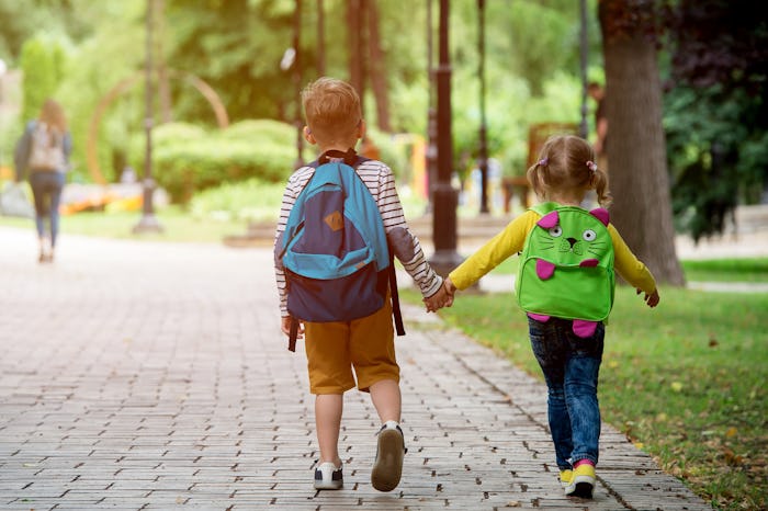Back to school. Happy children ready for primary school. Pupil on first day of classes. Boy and girl...