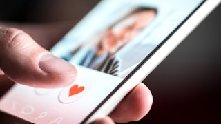 Dating app or site in mobile phone screen. Man swiping and liking profiles on relationship site or a...