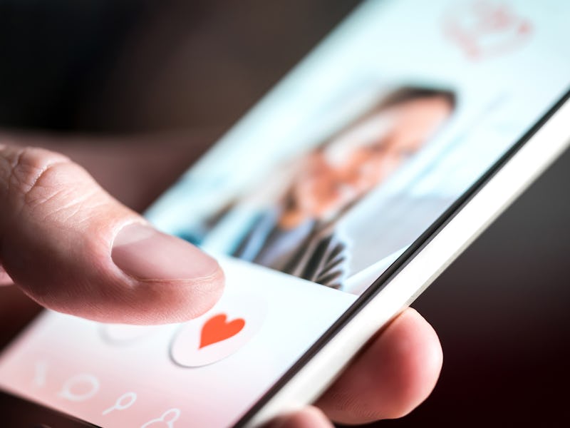 Dating app or site in mobile phone screen. Man swiping and liking profiles on relationship site or a...