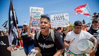 Demonstrators bang on pots and buckets as they march on Las Americas highway demanding the resignati...