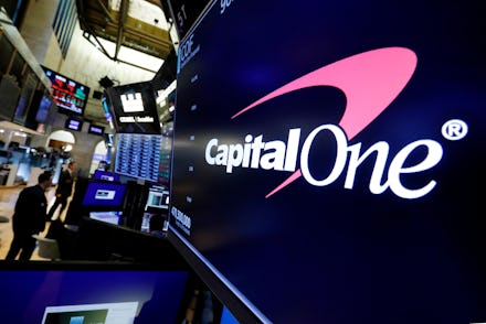 The logo for Capitol One Financial appears above a trading post on the floor of the New York Stock E...
