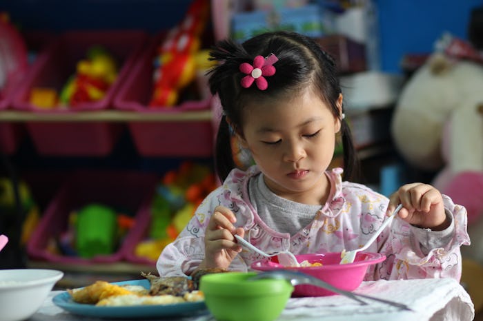 kid eating healthy food at home by yourself.family concept