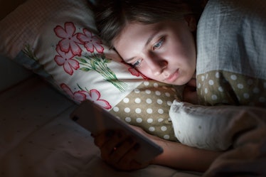 Sleepy woman awake late at night in bed surfing in web, can not fall asleep/ sleepy tired, social me...