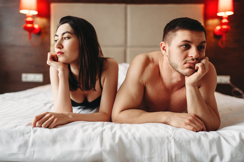 Love couple lies in bed, no sexual desire
