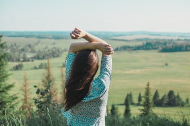 Girl in the nature enjoying fresh air and life in summer