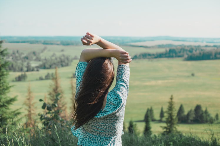 Girl in the nature enjoying fresh air and life in summer