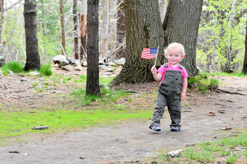 Young Boy Carrying American Flag Outside