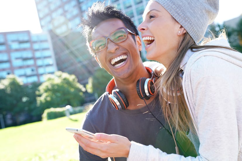 Hipster couple laughing at the park in NYC                            