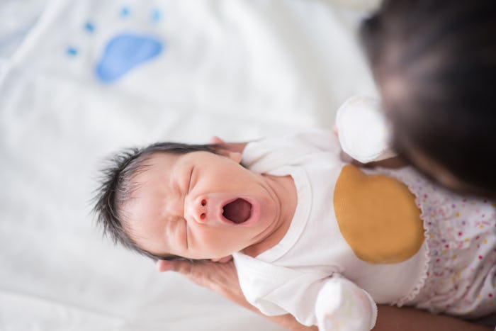 Cute asian baby newborn looking at grand mom 