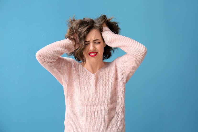 Portrait of beautiful stressed woman on color background