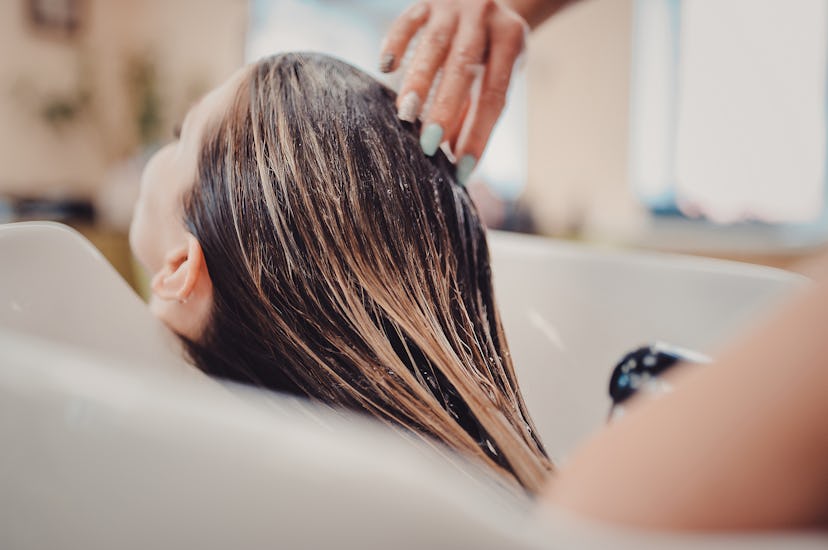 girl in a beauty salon. wash your hair, hair care, health. Process of washing your hair in a hairdre...