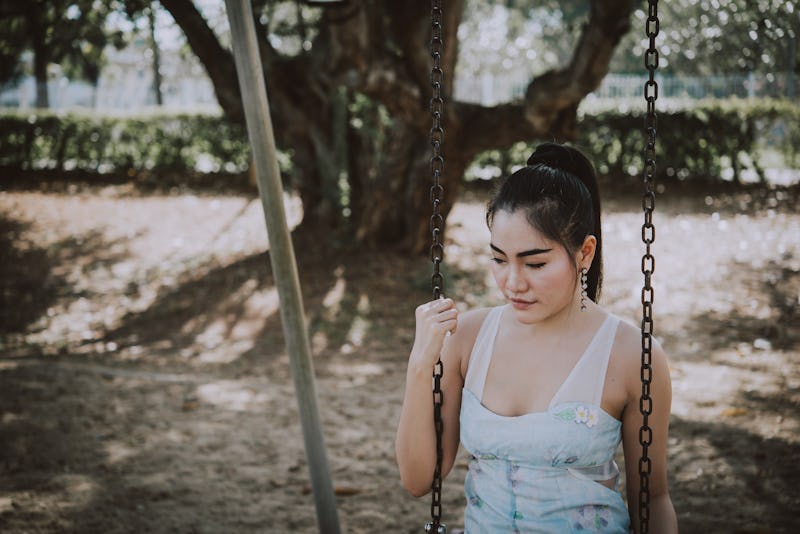 Portrait of sad asian woman cry in the park,Thailand people heartbreak concept