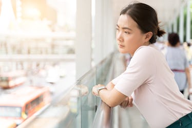 Sad woman standing in the city