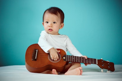 Asian child playing ukulele, Baby healthy and preschool concept