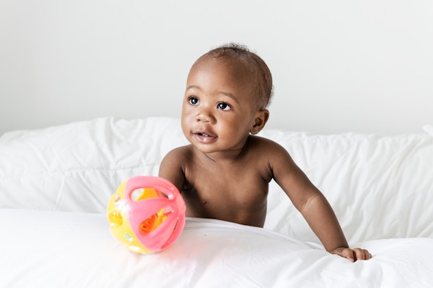 Baby playing on the bed