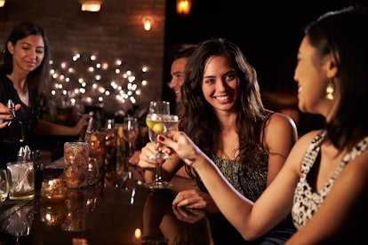 Female Friends Enjoying Night Out At Cocktail Bar